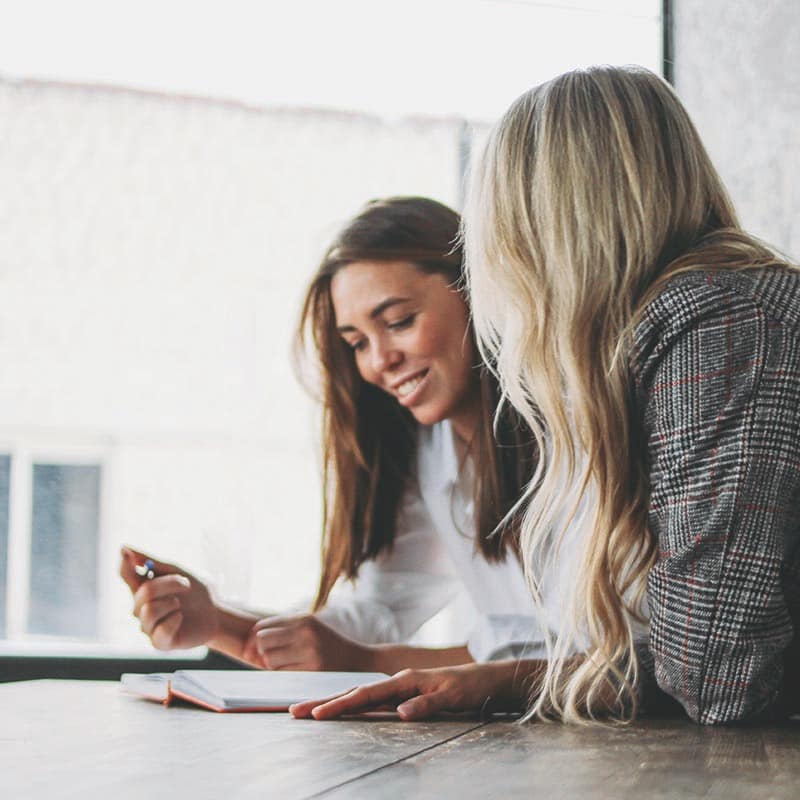 young-successful-women-colleagues-discussing case