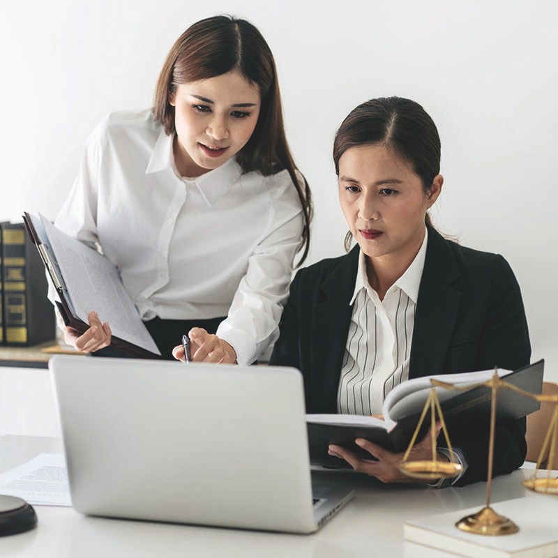 female-lawyer-is-holding-law-book-and-giving-advice