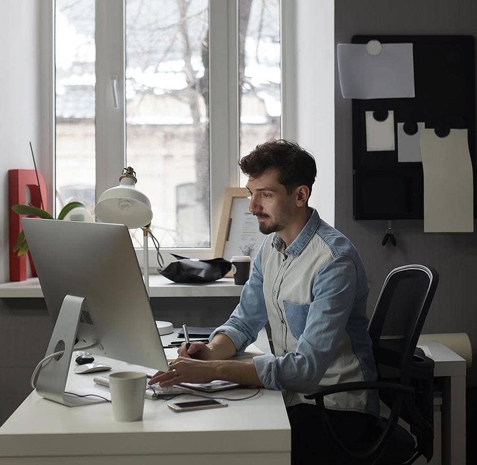 bearded man working at home
