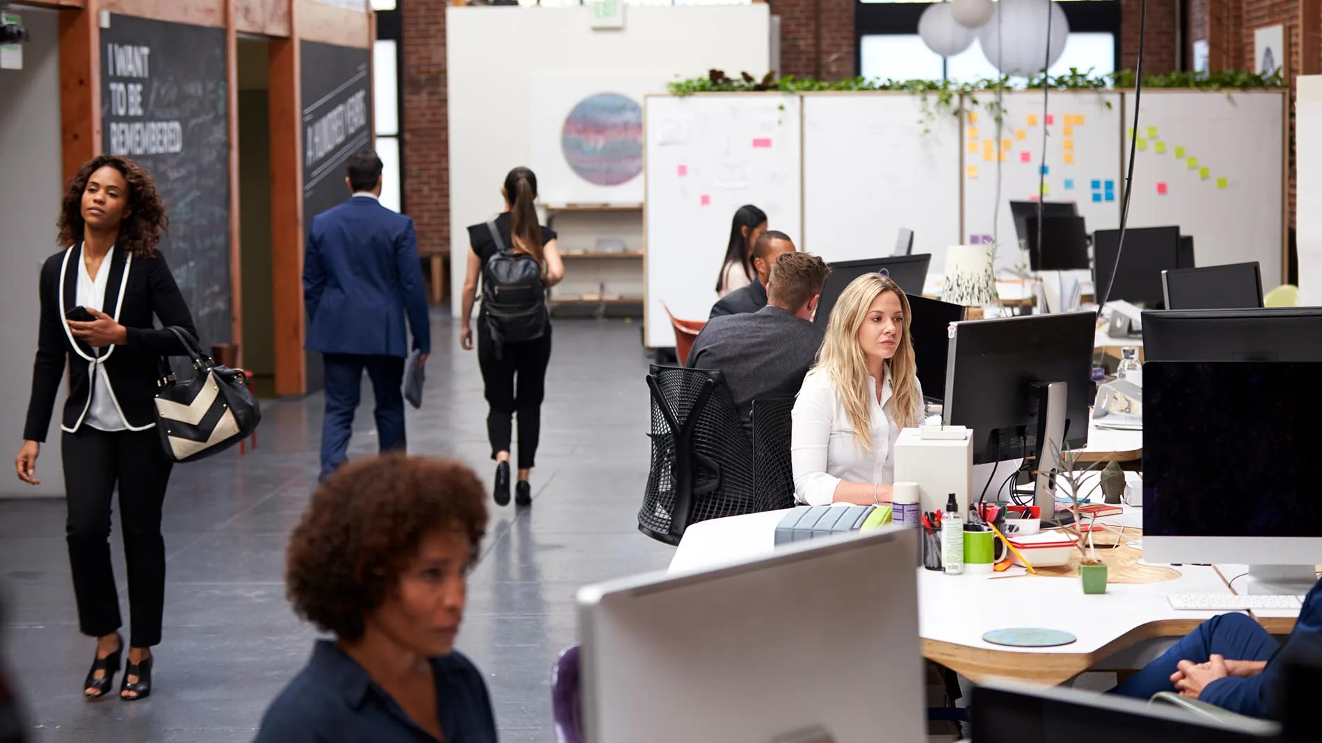 business team working at desks in modern open plan office