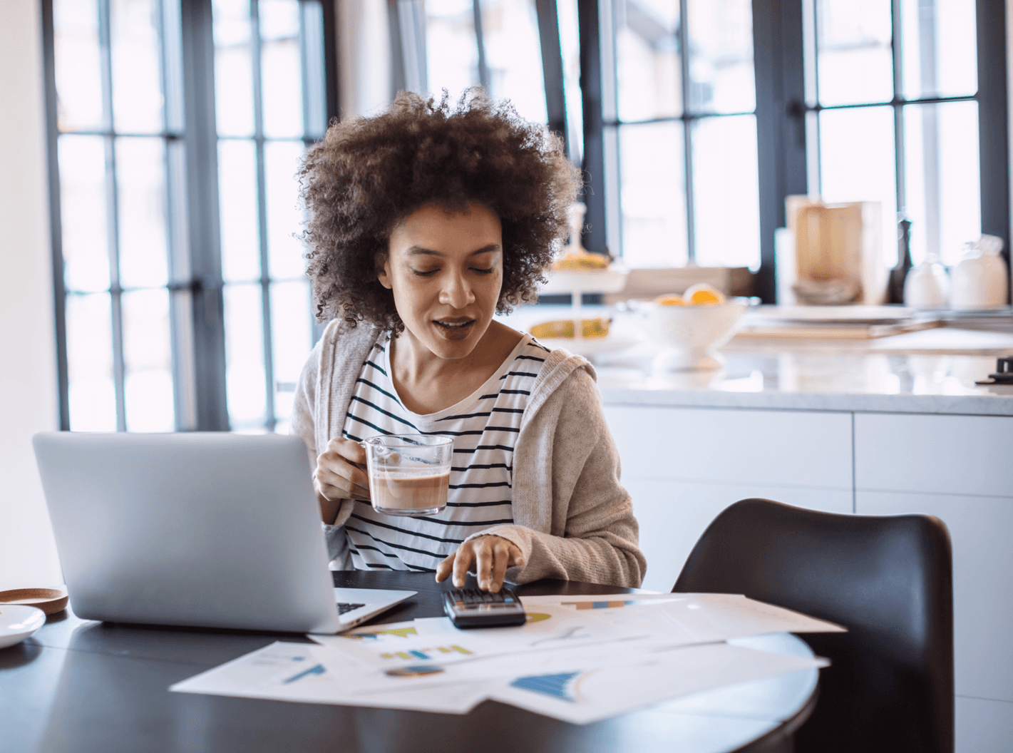 A consultant solicitor at working from home drinking a coffee.