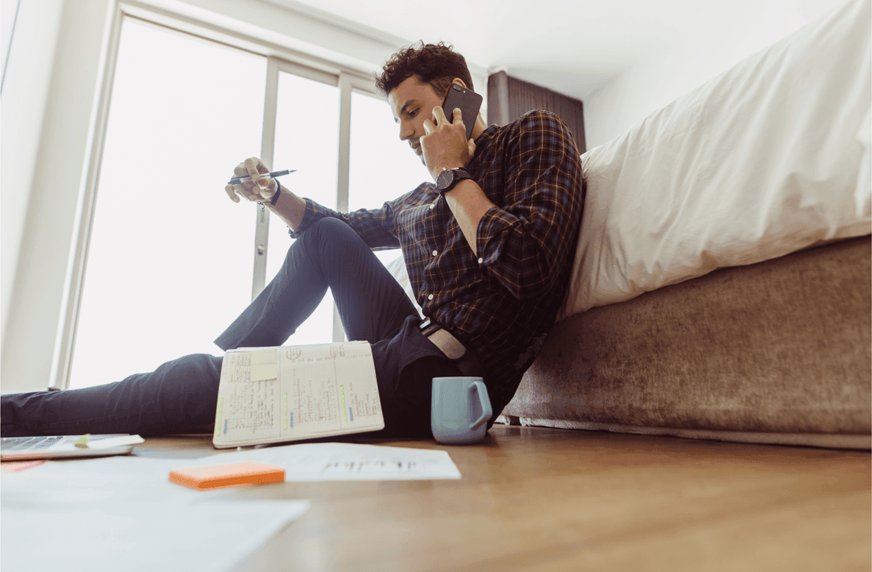 Man on the phone with paperwork