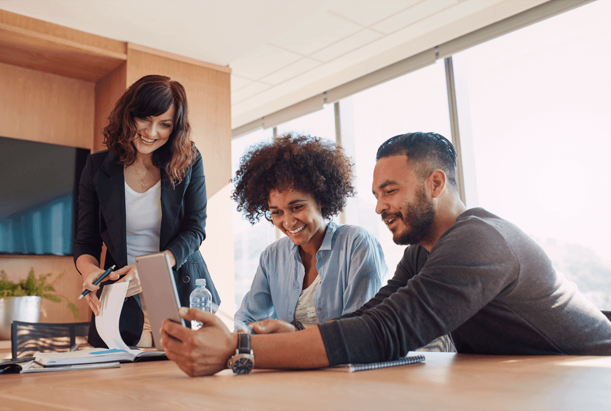 3 solicitors working around a desk
