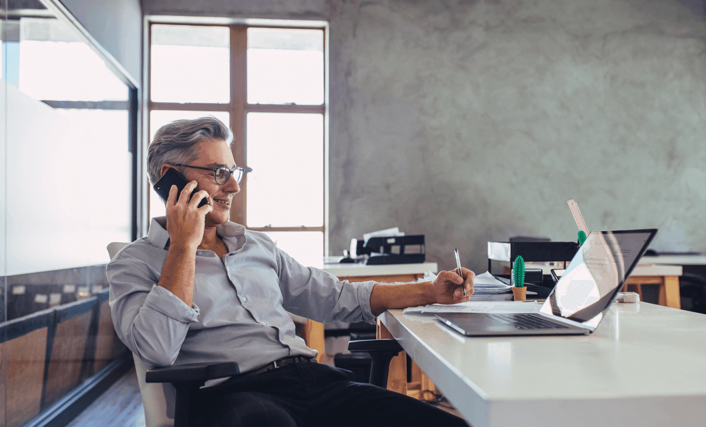 Man in an office on mobile phone