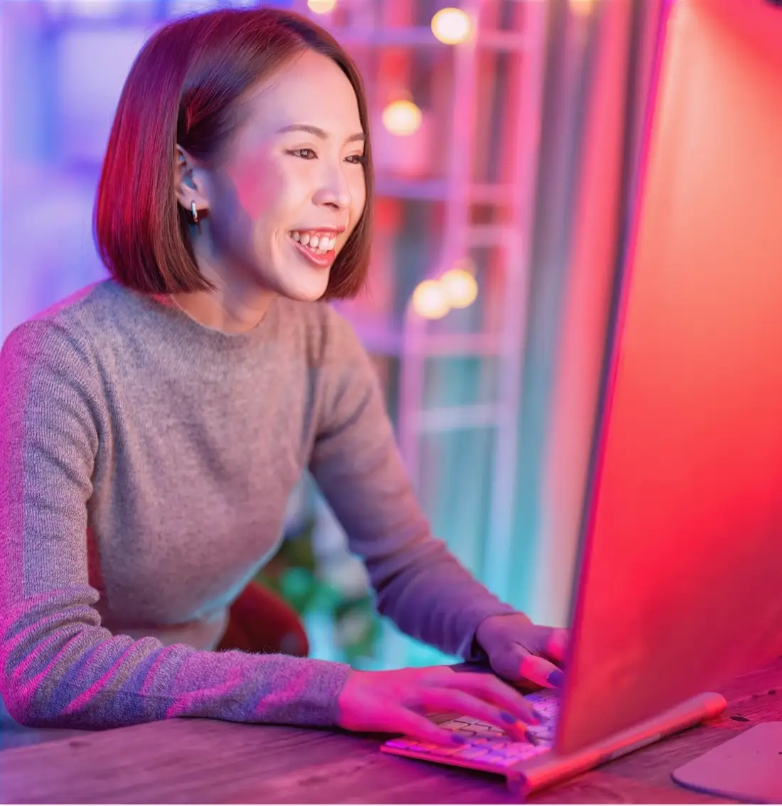 Smiling woman typing on a laptop