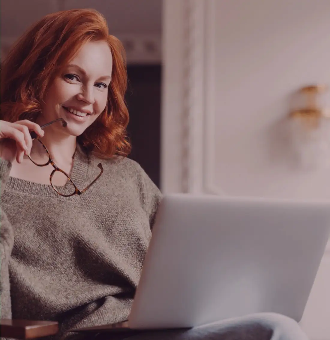 Smiling woman with a laptop at home